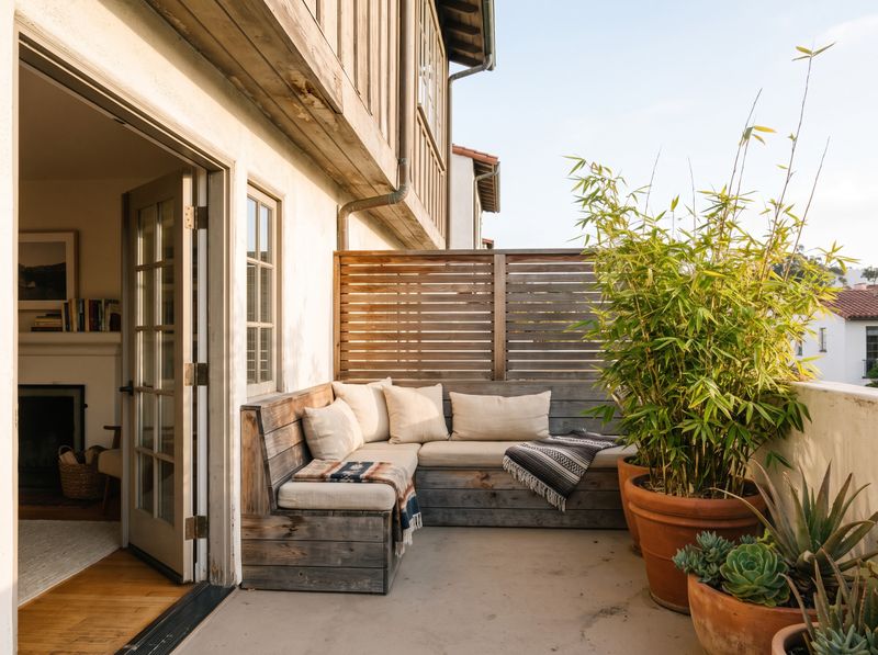 Corner Wooden Bench on Stucco Balcony