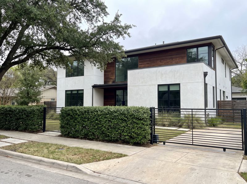 Black Aluminum Fence with Manicured Hedge