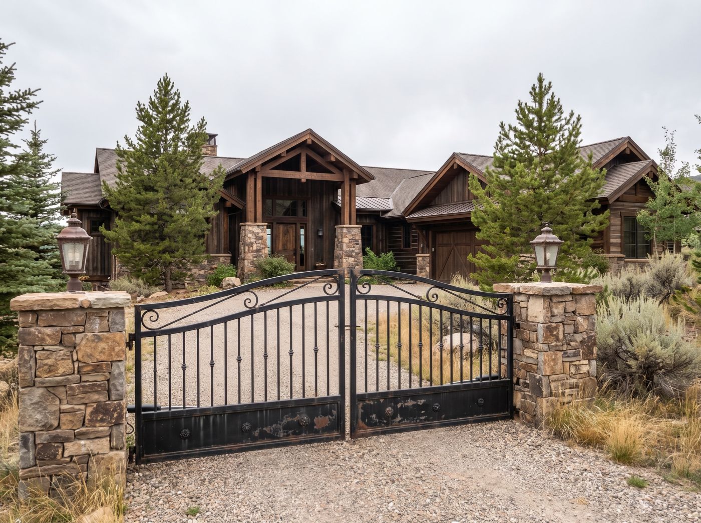 Metal Driveway Gate Between Stone Pillars