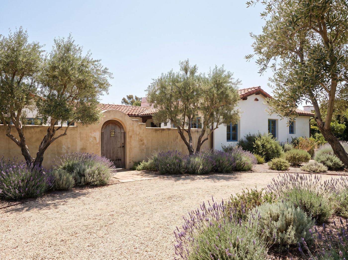 Gravel Front Yard with Arched Courtyard Gate