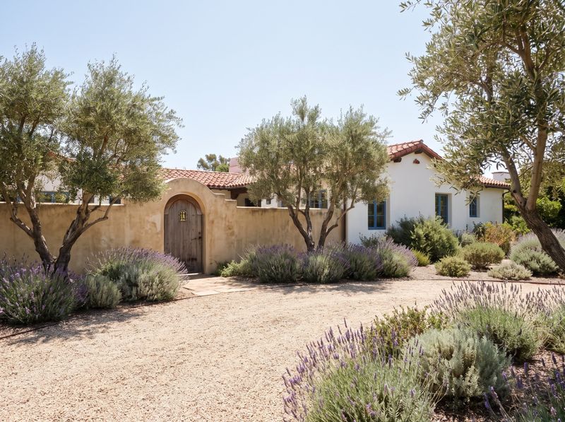 Gravel Front Yard with Arched Courtyard Gate