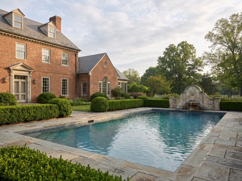 Stone Fountain by Rectangular Pool