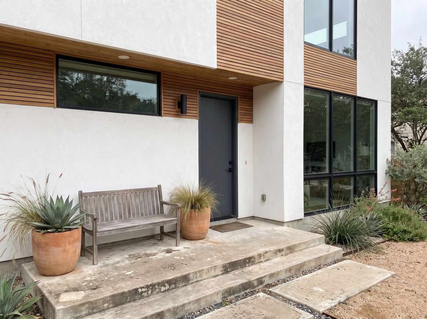 Concrete Front Porch with Wooden Bench